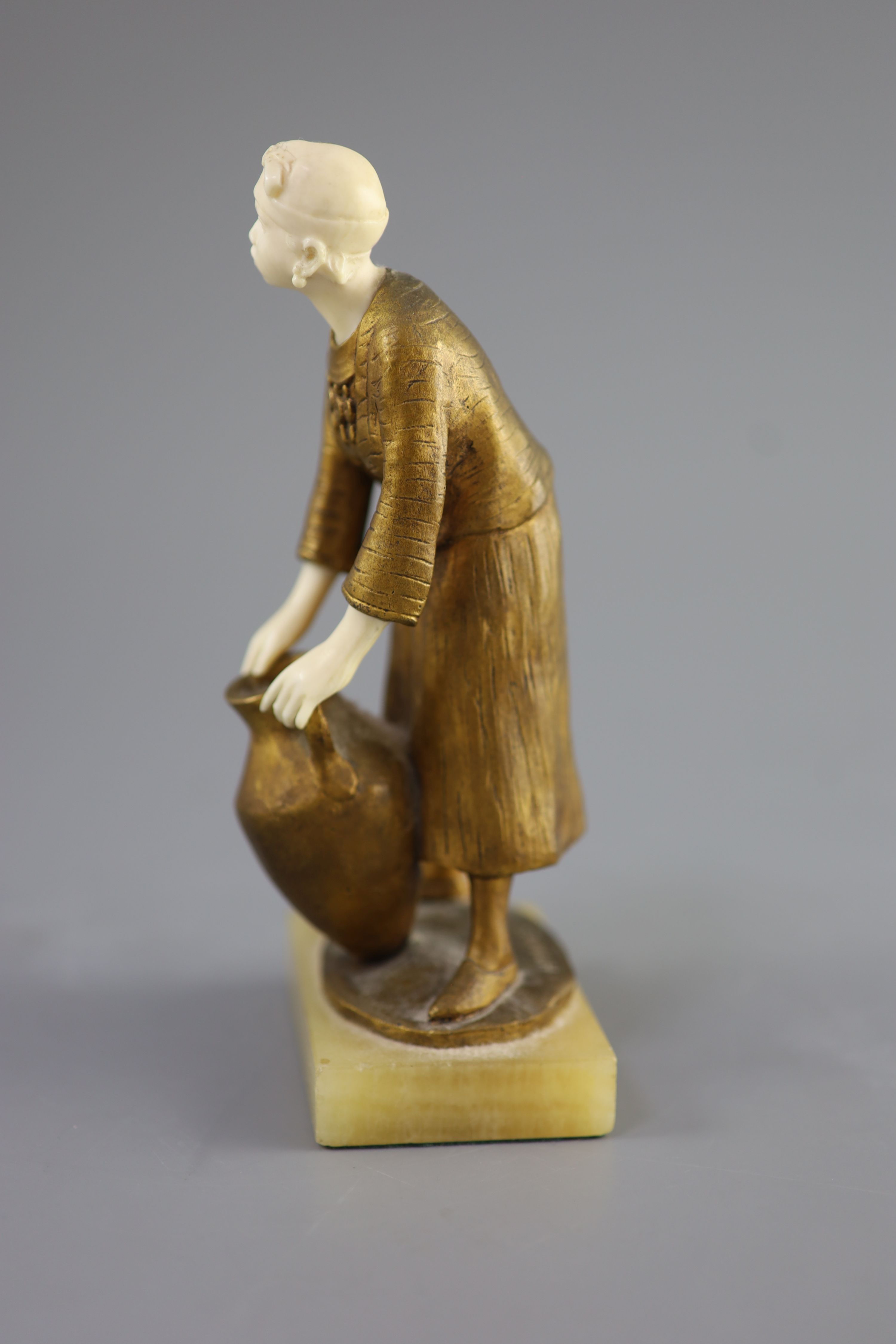 Hélène Maynard White (American, b.1870). A bronze and ivory study of an African girl with amphora base, c1920, 19cm high